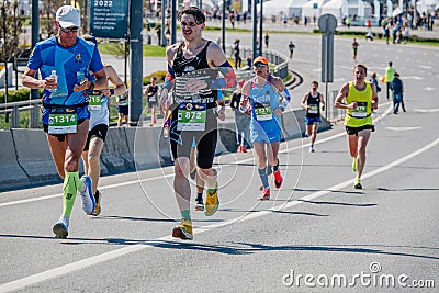 group male runners run down street during Kazan Marathon Editorial Stock Photo