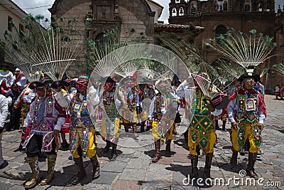 A group of man wearing traditional clothes and masks during the Huaylia on Christmas day in front of the Cuzco Cathedral Editorial Stock Photo