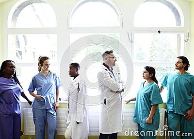 Group of medical professionals discussing in the hallway of a hospital Stock Photo