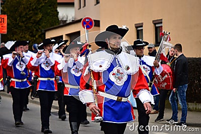 Group of men in blue and red troubadour costumes playing flutes and parading on the German Carnival Editorial Stock Photo