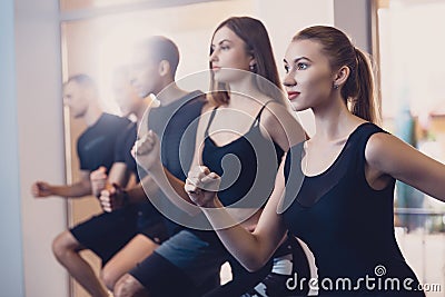 Group men and women performs a physical exercise. Stock Photo