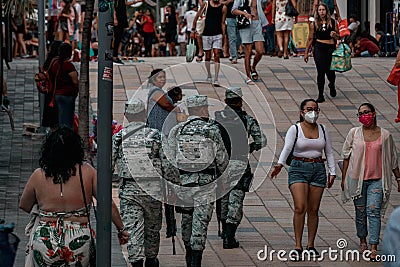 Group of Mexican national guard walking among people on the street in Mexico Editorial Stock Photo