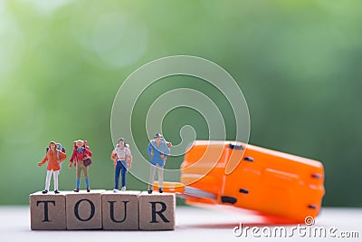 Group miniature traveler and hiker backpack standing on wooden text TOUR with suitcase Stock Photo