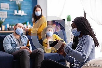 Group of mixed race friends looking at photo on smartphone Stock Photo