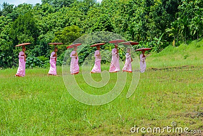 Group of Mon nuns walking toward to ruined Buddhist church Editorial Stock Photo