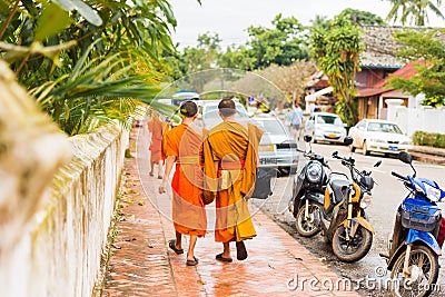 Group of monks on a city street, in Louangphabang, Laos. Copy space for text. Editorial Stock Photo