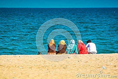 Group of Moroccan women sitting on the beach Editorial Stock Photo