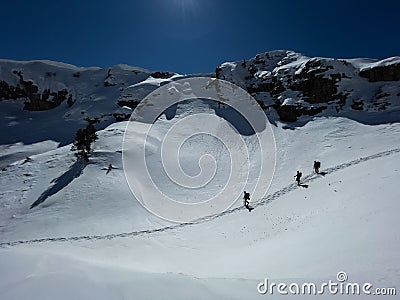 Group of mountaineers returning from the mountains by following the steps they took Editorial Stock Photo