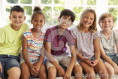 Group Of Multi-Cultural Children On Window Seat Together Stock Photo