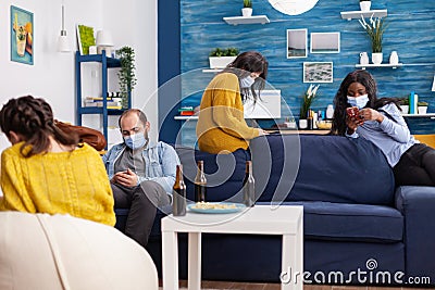 Group of multi ethnic antisocial friends keeping social distancing Stock Photo