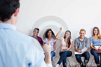 Group of multi ethnic students listening to teacher Stock Photo