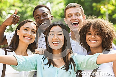 Group of multi-ethnic teen friends taking selfie picture outdoors Stock Photo