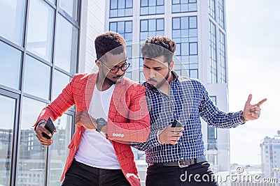 Group of multi ethnic youngsters chilling in urban outdoor background Stock Photo