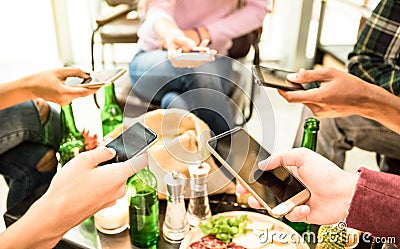 Group of multicultural friends having fun on mobile cell phones Stock Photo