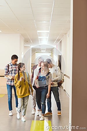 group of multiethnic high school classmates walking by school Stock Photo