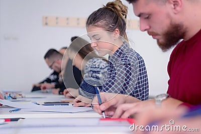 Group of multiethnic university architecture students working on practice lessons. Looking for solution during class Stock Photo