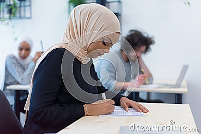 Group of multiethnic university students working on practice lessons. Looking for solution during class Stock Photo