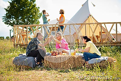 Group of multiracial friends meeting together at the campsite they have a picnic time together discussing drinking enjoy Stock Photo
