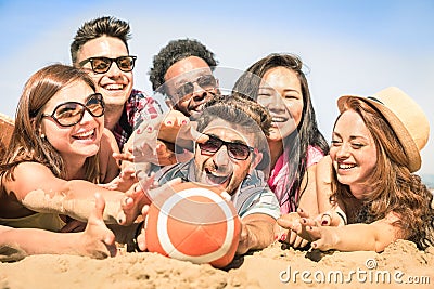 Group of multiracial happy friends having fun at beach games Stock Photo