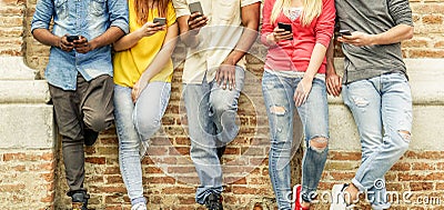 Group of multiracial students watching smart mobile phones in university break - Young people addiction to new technology trends Stock Photo