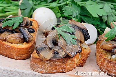 Group of mushroom bruschetta on chopping board Stock Photo