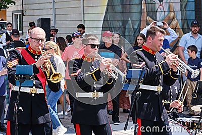 Group of musicians is performing a lively show on the public street during a parade in Dartmouth Editorial Stock Photo