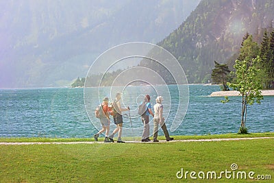 Group of people in the nature nordic walking. Sun glare effect Editorial Stock Photo
