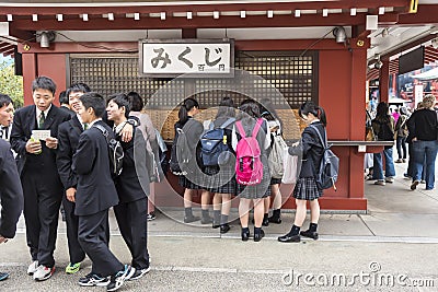 Group o schoolboys and girls buying omikuji paper fortune Sensoji Tokyo Editorial Stock Photo