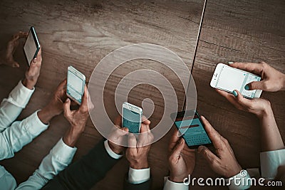 Group of office workers chatting on mobile phones while using text applications in smartphones. Mobile business meeting Editorial Stock Photo