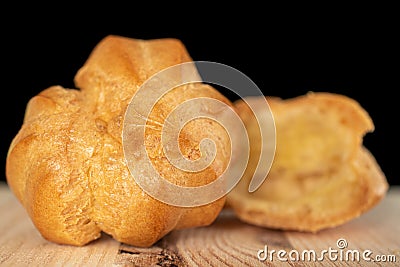 Golden baked profiterole on black glass Stock Photo