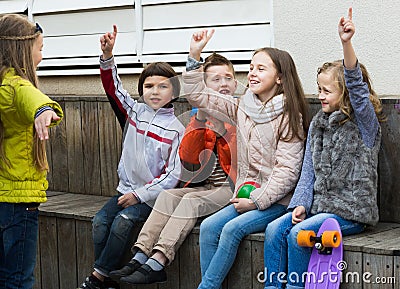 Group of ordinary children playing charades Stock Photo