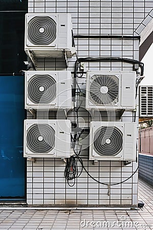 Group of outer air conditioners on wall of residential building. Maintenance house facilities.Climate technology. Stock Photo