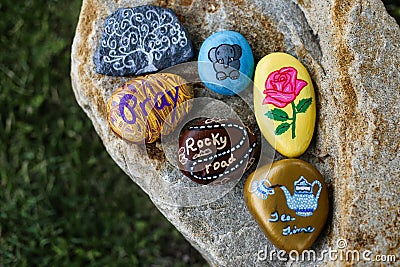 Group of painted rocks on a small boulder Stock Photo