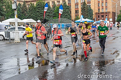 Group of participants at the head of pacemakers running on the central street of Dnipro city Editorial Stock Photo