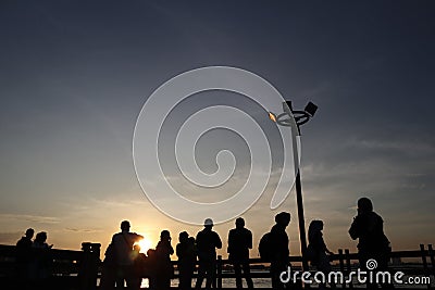 A group of peolpe enjoying sunset in Ancol Beach Stock Photo