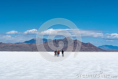 Group of people on an adventure on the desert salt flats of Utah. Editorial Stock Photo