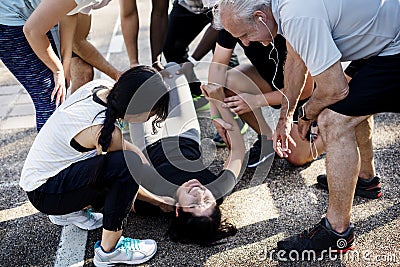 Group of people assisting an injured person Stock Photo