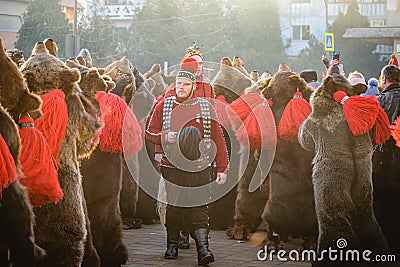 Group of people in bear costumes in the New Year's eve parade doing the Bear Dance Ritual Editorial Stock Photo