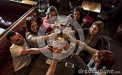 Group of people celebrating in a pub drinking beer Stock Photo