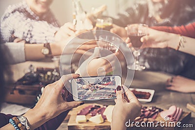 Group of people clinking drinks and taking photo Stock Photo