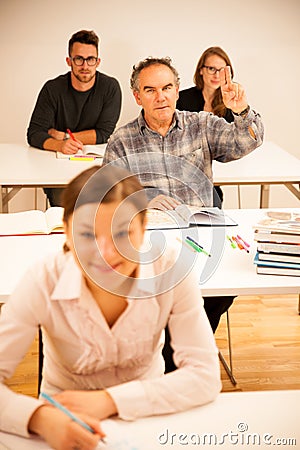 Group of people of different age sitting in classroom and attend Stock Photo