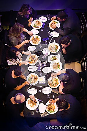 Group of people dining or eating Editorial Stock Photo