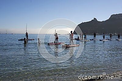 A group of people dressed as santa claus doing paddle in the Poetto beach in Cagliari - Sardinia - ITALY 2022 DECEMBER Editorial Stock Photo