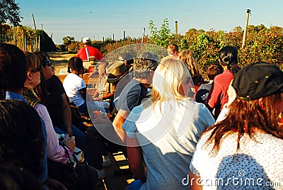 A group of people enjoy a hayride through a farm Editorial Stock Photo