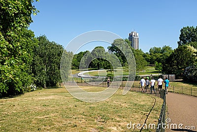 A group of people walking into nature in Hyde park Editorial Stock Photo