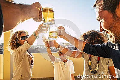 Group of people families and friends having fun together clinking with beers and orange juice - friendship celebrating event in Stock Photo