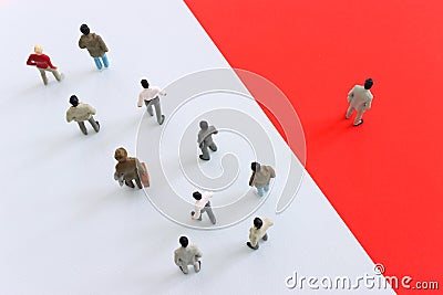 group of people going in one direction and a unique person heading in a different direction Stock Photo