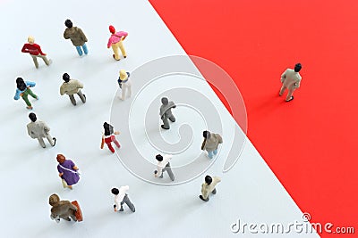 group of people going in one direction and a unique person heading in a different direction Stock Photo