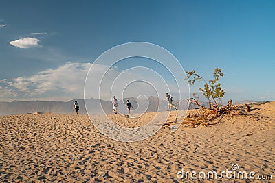 Group of people hiking in desert. Mesquite Sand Dunes vista point in Death Valley National Park, California Editorial Stock Photo