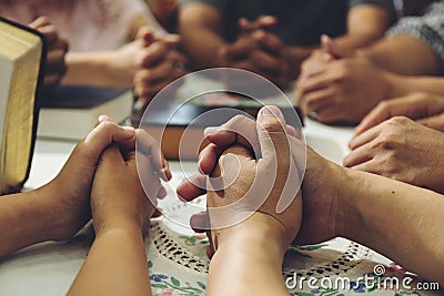 Group People hold hands to pray for God Stock Photo